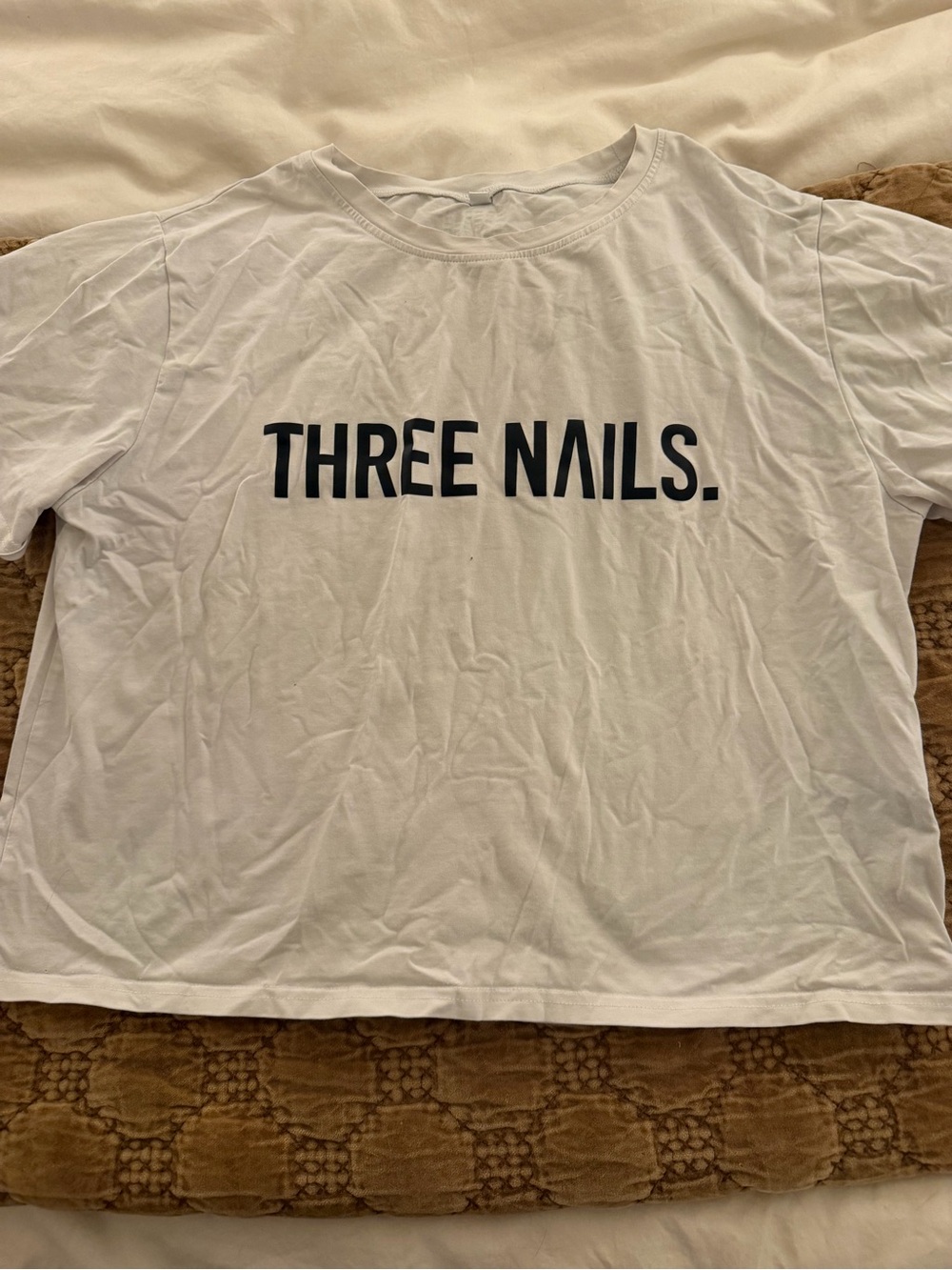 White Cropped Graphic Tee with 'THREE NAILS.' Text